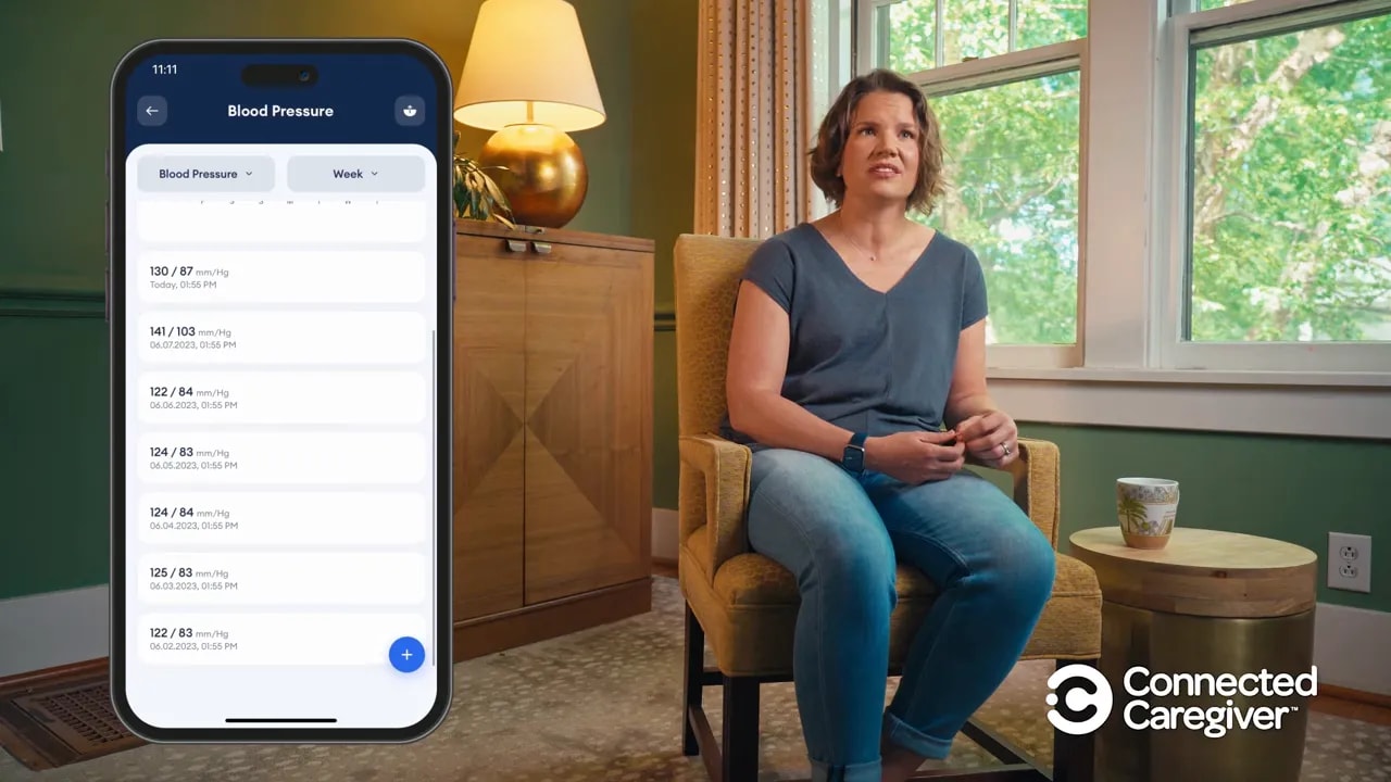 Phone app showing multiple logged care readings in a list next to a seated caregiver