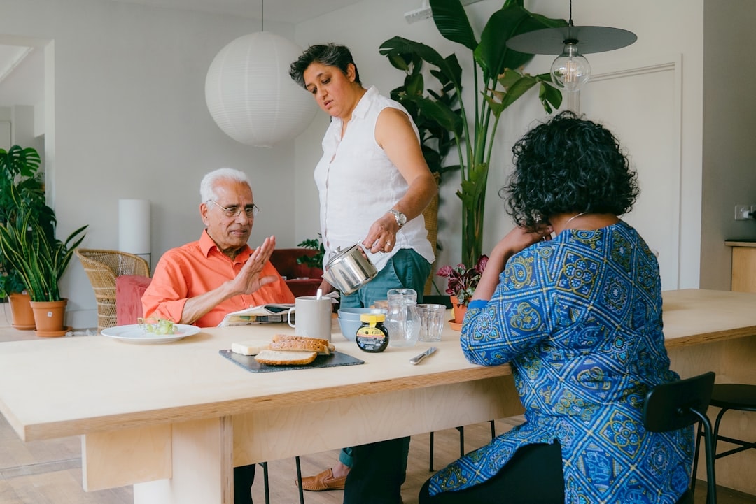 caregiver helping older person eat and drink