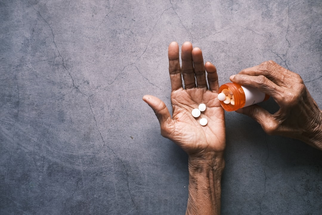 home care aide helping client take prescribed medicine