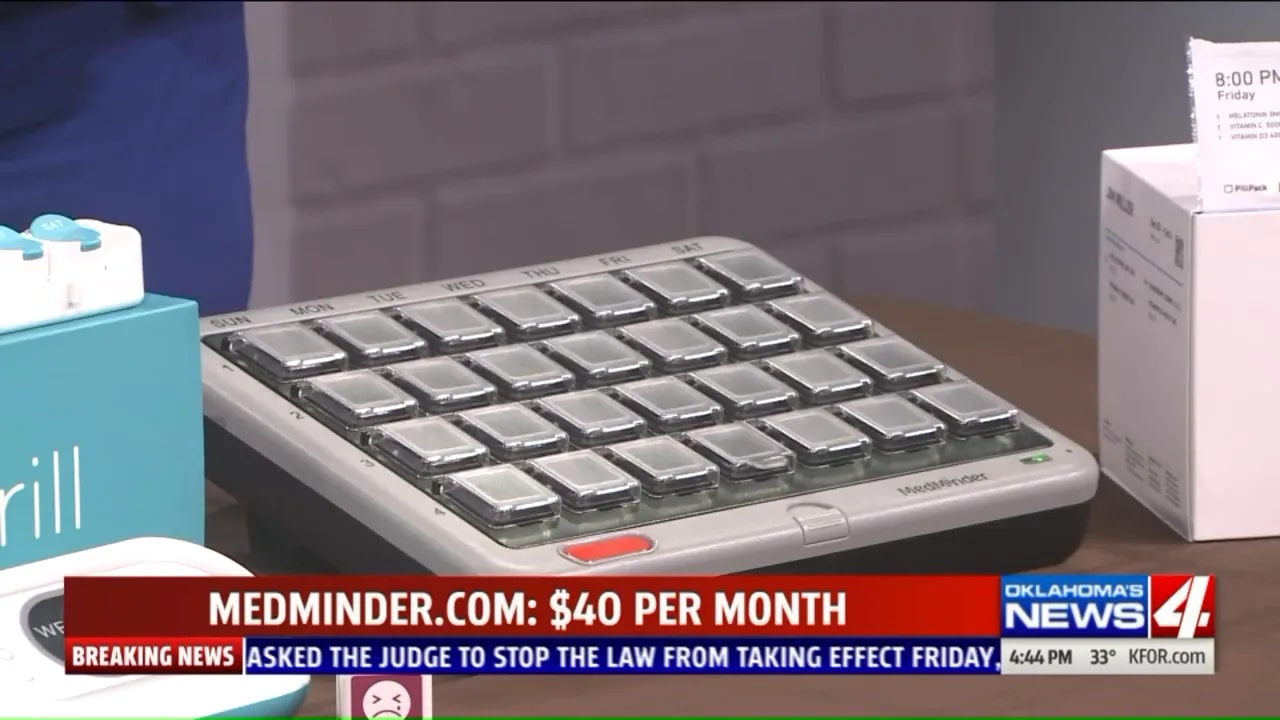 large medminder pill dispenser with many labeled compartments on a tabletop