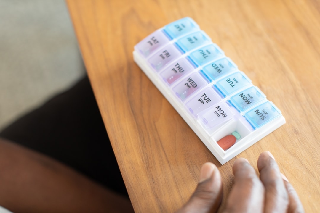 senior taking medication pill organizer